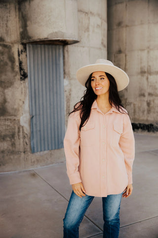 pink button up jacket with white hat