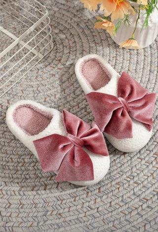 Pair of white slippers with pink velvet bows 
