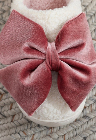 Pink velvet bow on a white slipper