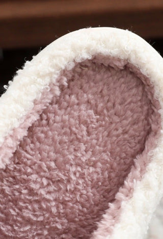 Close up of cream slippers with pink inside