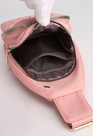 Pink shoulder bag with gold zipper showing inside bag