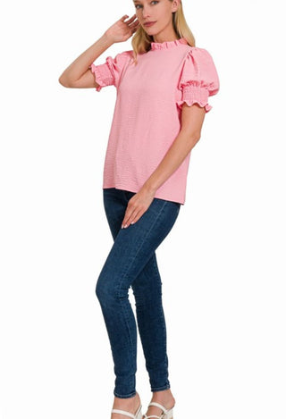 pink woven top with jeans