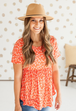 Coral floral top with tan hat