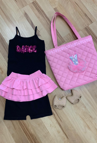 A set of dancewear consisting of a black camisole, black shorts, a pink skirt, and a pink bag 