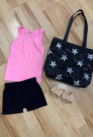 girls pink tank top, black shorts, black star bag