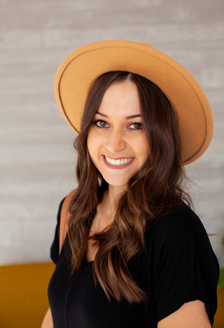 black jumpsuit with tan hat