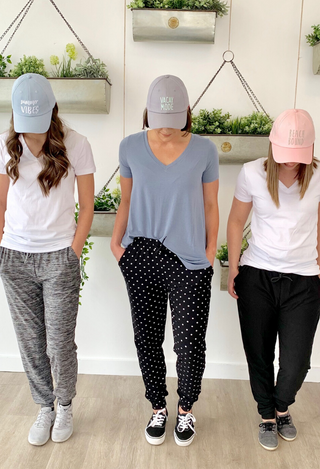 Joggers in grey, black dot and black with white and blue tees and hats