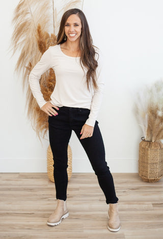 long sleeve cream top and black jeans