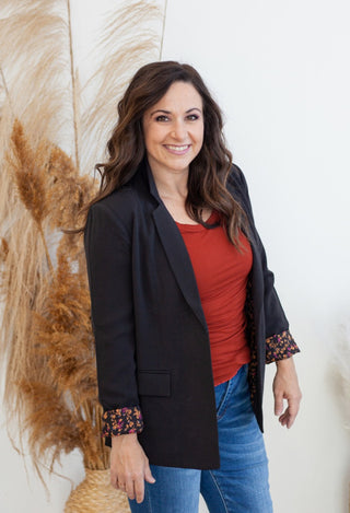 Black blazer with red top and jeans
