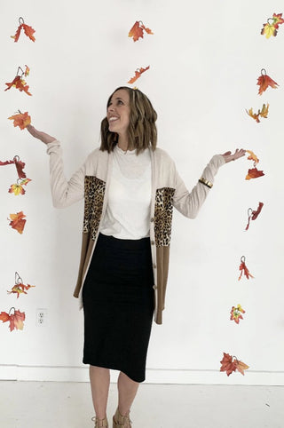 black skirt with white top and leopard cardigan