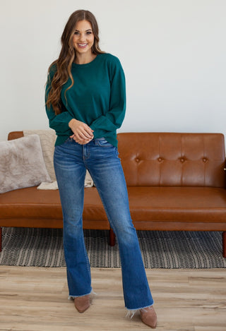 Teal long sleeve sweater with flare jeans