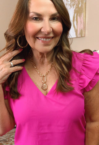 Magenta dress close up wiith gold jewelry